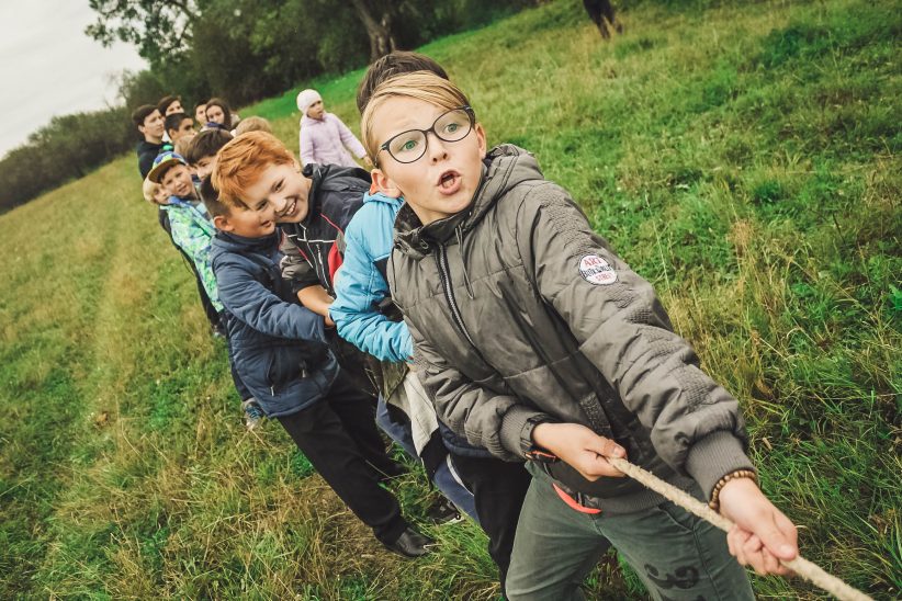 Bunch of kids playing tug of war