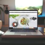 laptop sitting on a table with a website.
